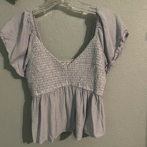 A white and blue striped women's blouse in the size medium